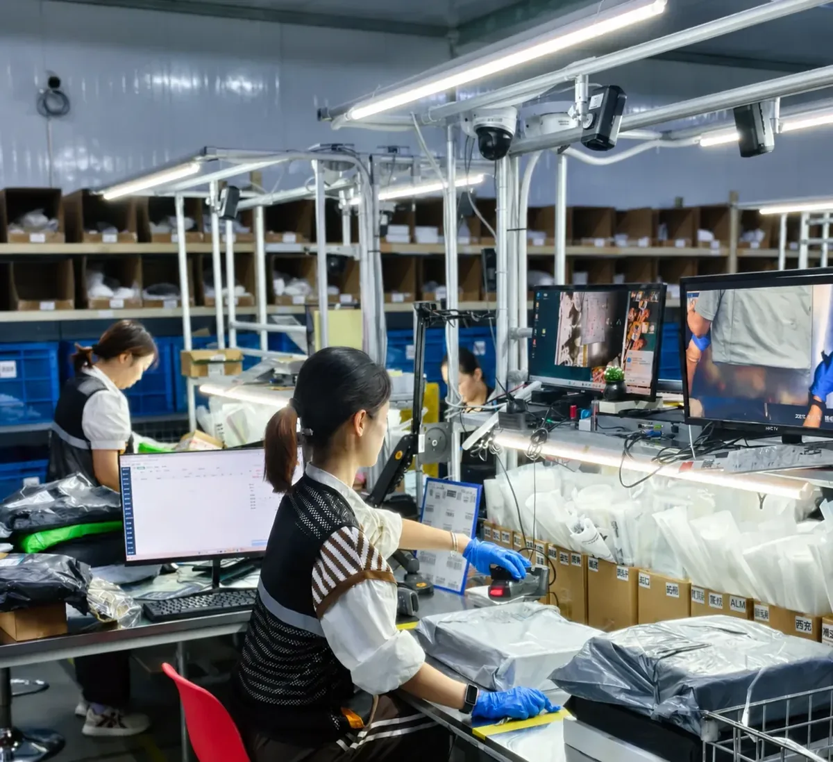 Warehouse team scanning and inspecting parcels at organized workstations in China
