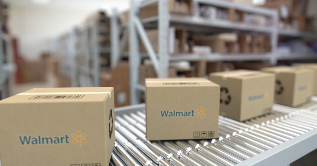 Walmart-branded cardboard boxes moving along a roller conveyor belt inside a warehouse, representing Walmart WFS prep services in China.